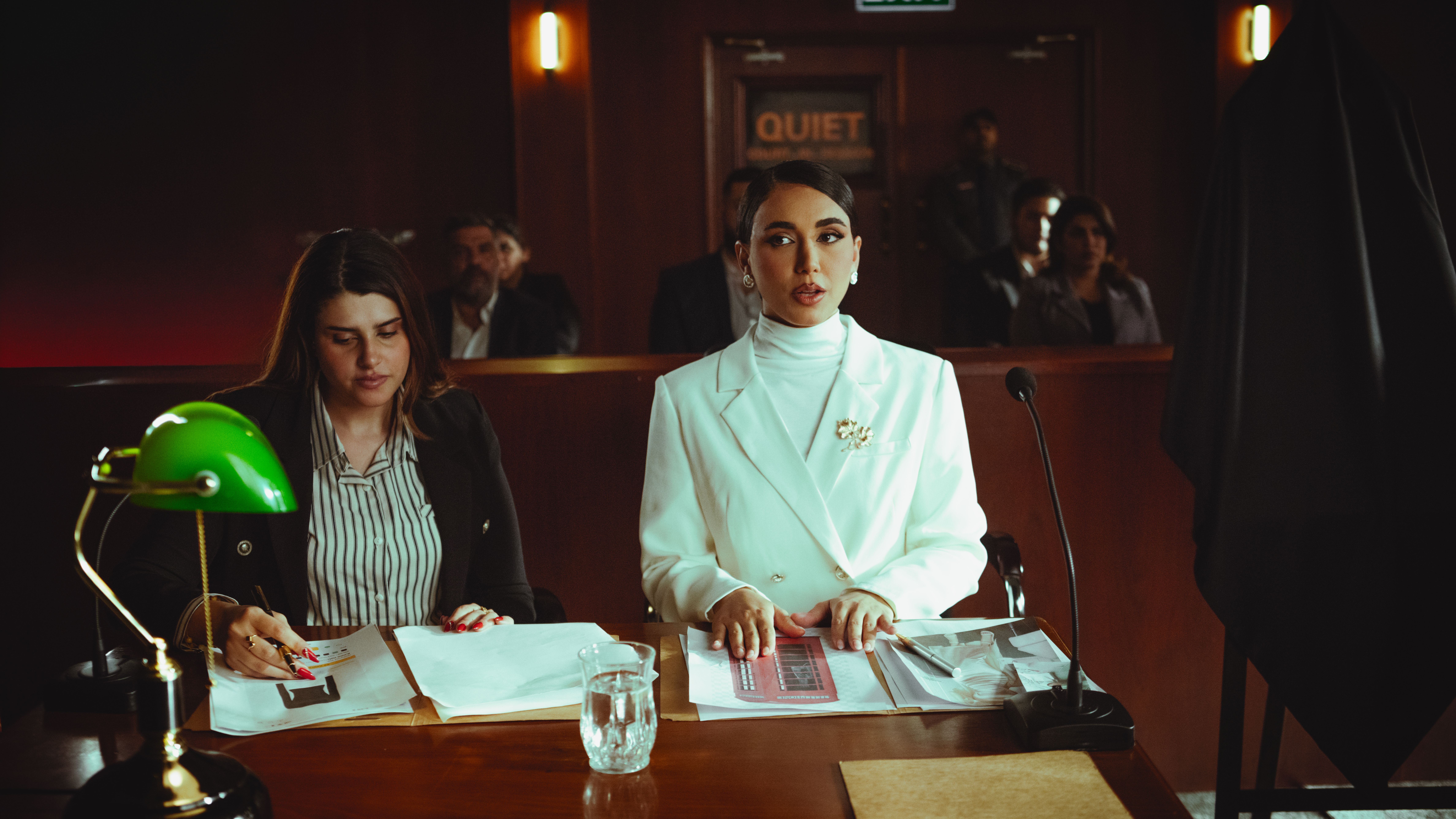 Two female lawyers reviewing legal documents in a courtroom, illustrating access to justice through lawsuit funding