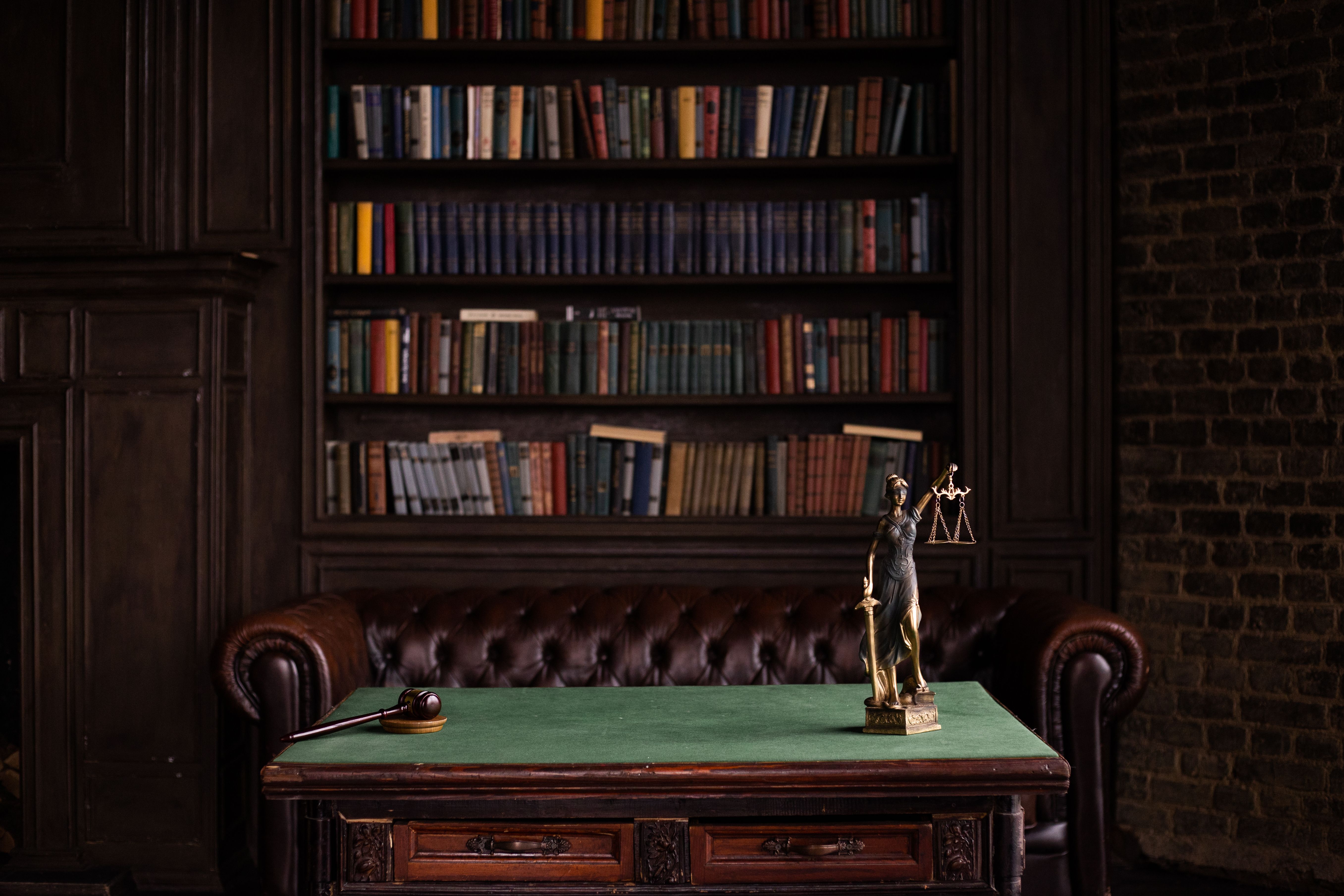 A classic study room with shelves of law books, a gavel, and a Lady Justice figurine, evoking litigation finance