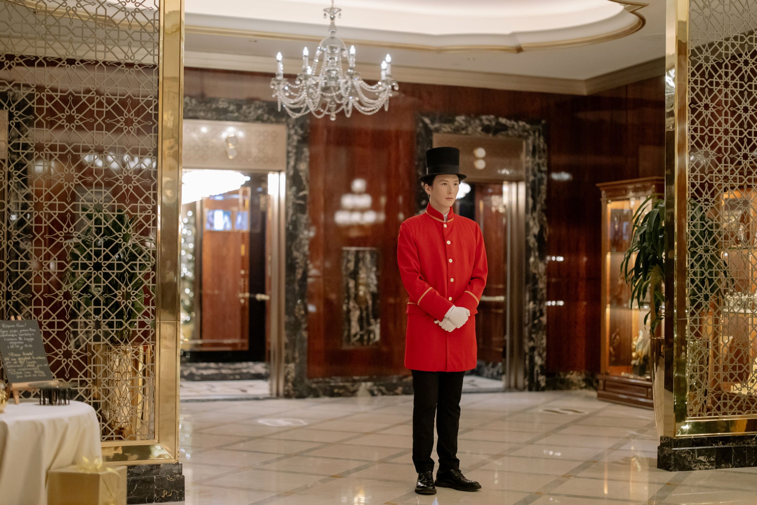 Elegant hotel lobby with a uniformed doorman ready to welcome guests with personalized service